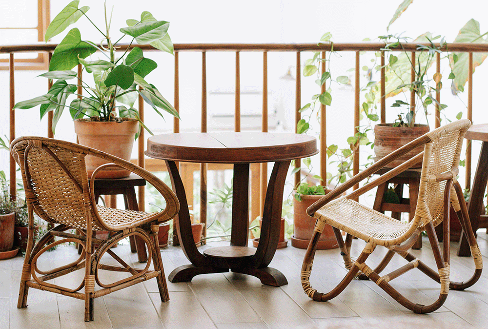 Botanical urban balcony with rattan and wooden furniture
